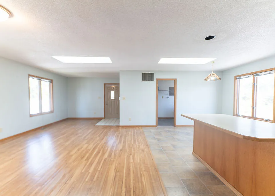 Open concept living room, dining space, and kitchen with 2 skylights