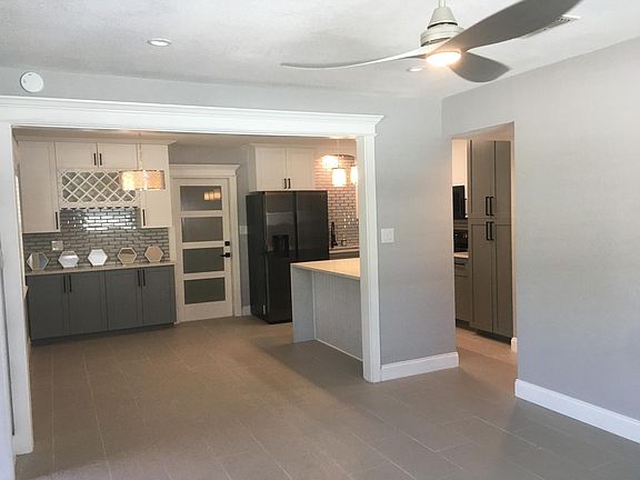 Spacious entrance! Dining area on left. Counter overhang designed for bar stools. Ceramic floor tile throughout home.