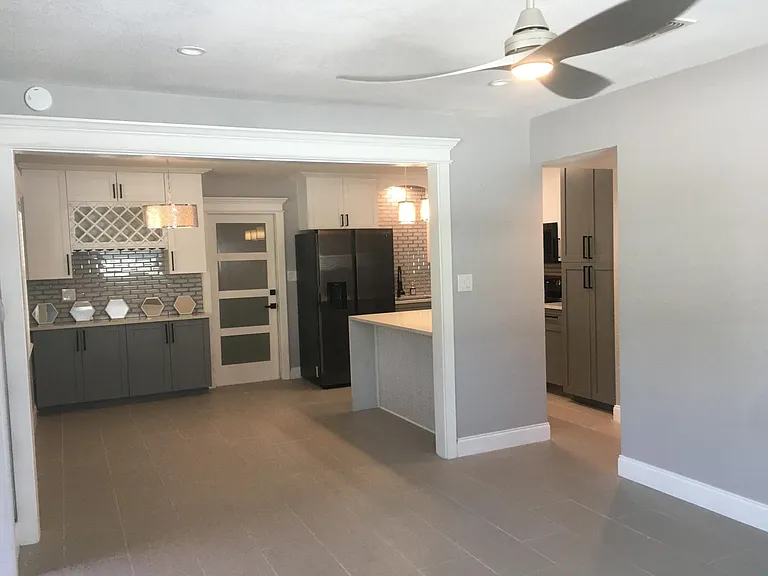 Spacious entrance! Dining area on left. Counter overhang designed for bar stools. Ceramic floor tile throughout home.