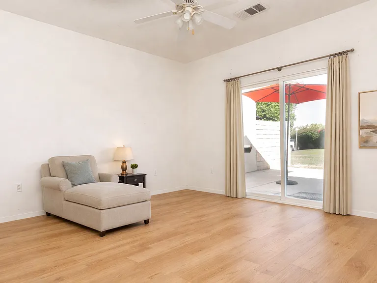 Virtual staging - Primary bedroom with access to the outside patio.
