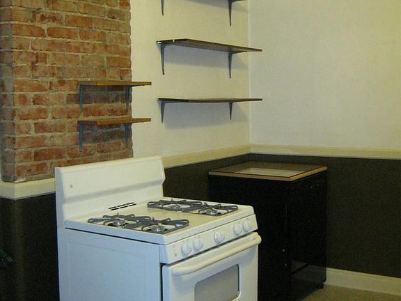 View to kitchen stove and portable dishwasher