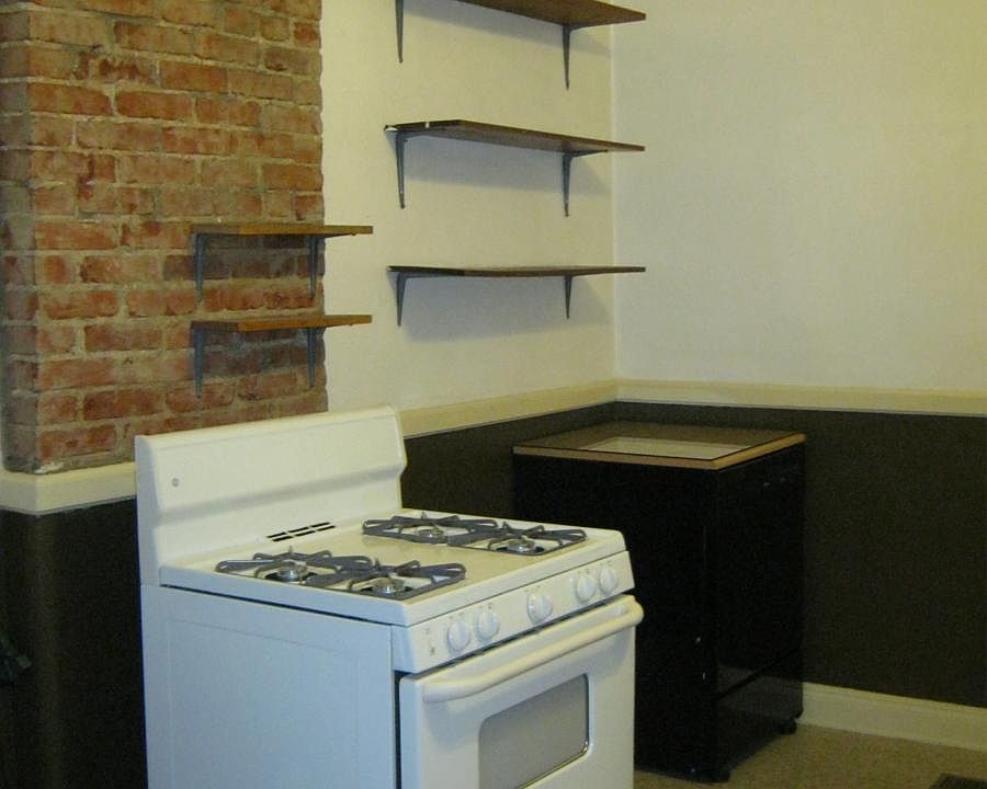 View to kitchen stove and portable dishwasher