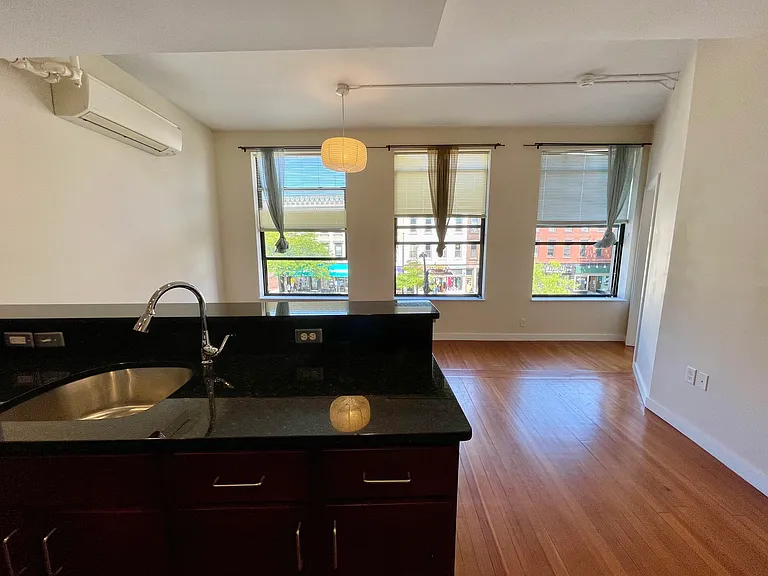 Kitchen sink faces the living room with northwest windows that look out on to Main St.