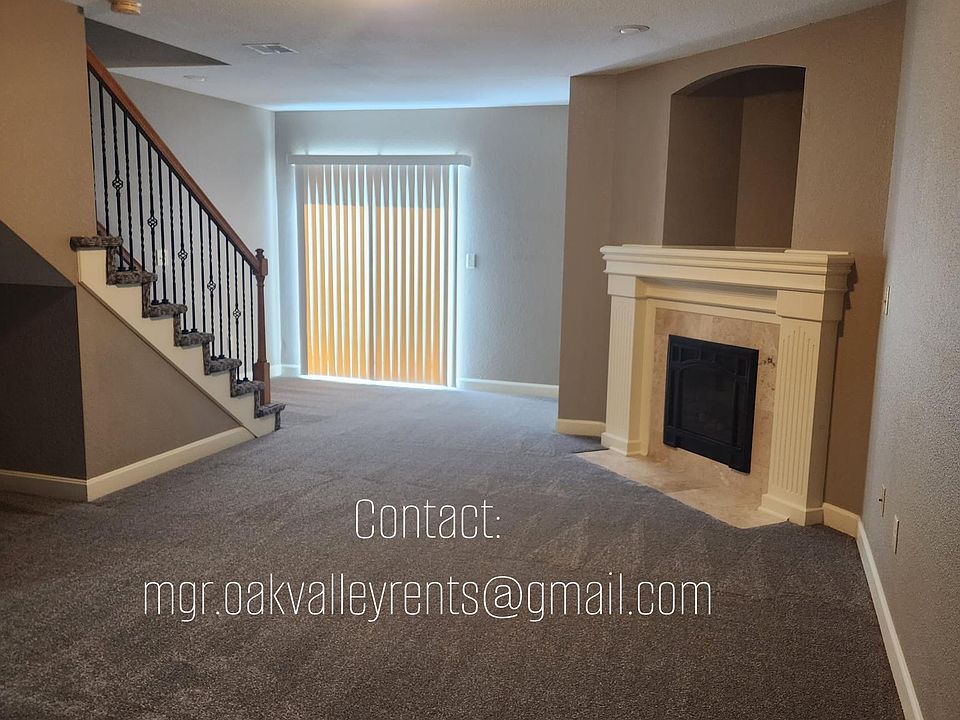 Living room with electric fireplace and entry to patio