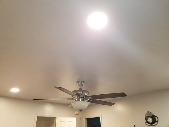 ceiling fan and recessed lights in the living area