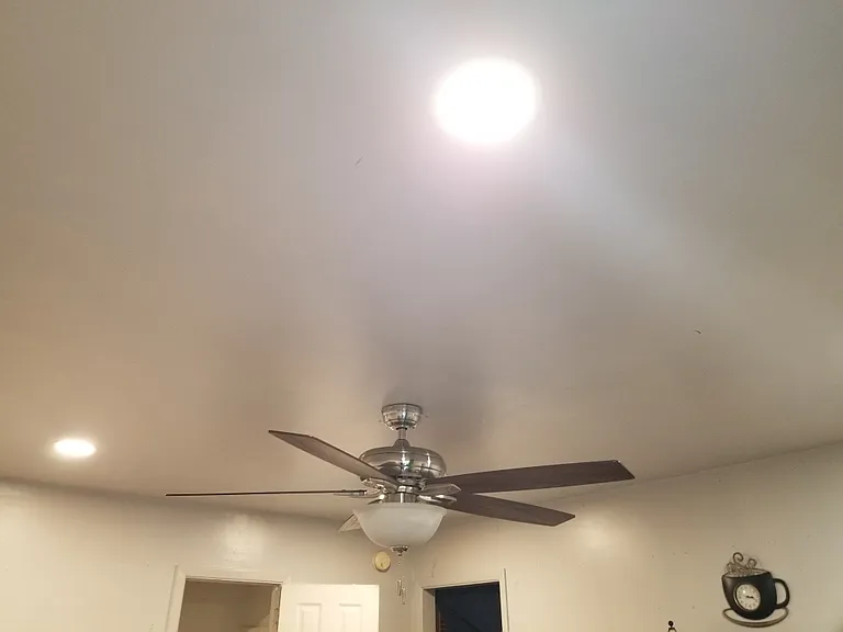 ceiling fan and recessed lights in the living area