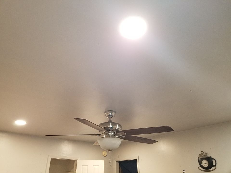 ceiling fan and recessed lights in the living area