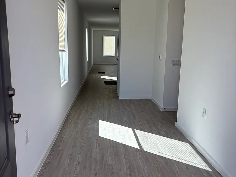 Front door hall way leads to kitchen and living room.