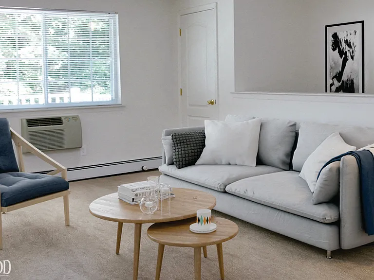 Living room set with throw pillows and blankets at Lakeside Village, East Patchogue
