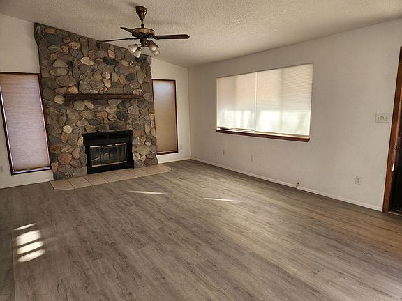 Living room with wood burning fireplace.