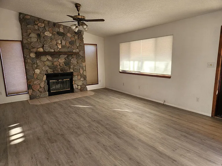 Living room with wood burning fireplace.