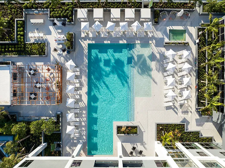 Indulge in the Miami sun on our expansive pool deck, offering luxury seating and a poolside bar