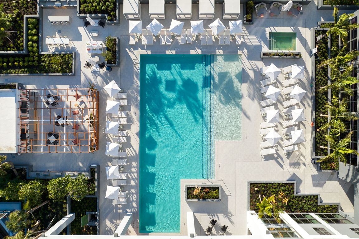 Indulge in the Miami sun on our expansive pool deck, offering luxury seating and a poolside bar