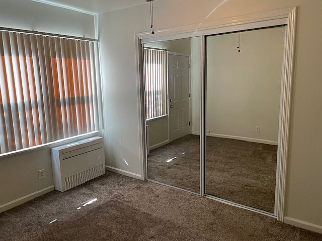 Bedroom with large mirrored closet ( with lights)