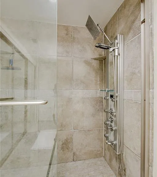 Bathroom # 2 with shower panel and stand-in shower, glass sliding door