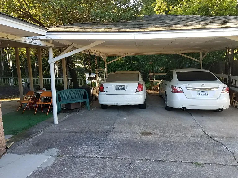 The carport parking comes along with the room rental. There is an entrance into the Garden Room from the carport entrance. There is a side morning patio between the carport and garden room.