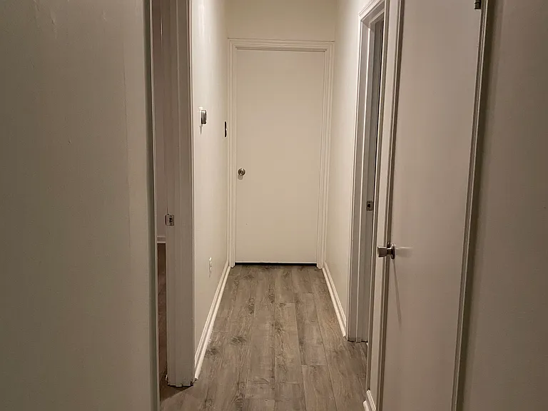 Hallway _ leads to primary bedroom (end of the hall), second bedroom (left), second/hall bathroom (right), and laundry room (right)