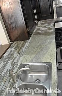 Kitchen
						:
						Granite countertops and mosaic tile backsplash.