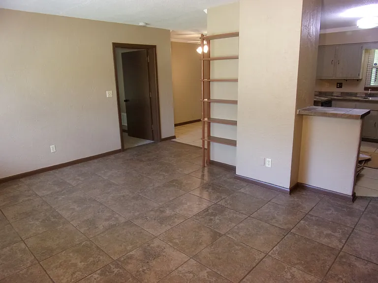 LIVING ROOM WITH VIEW OF MASTER BEDROOM - CUSTOM SHELVING