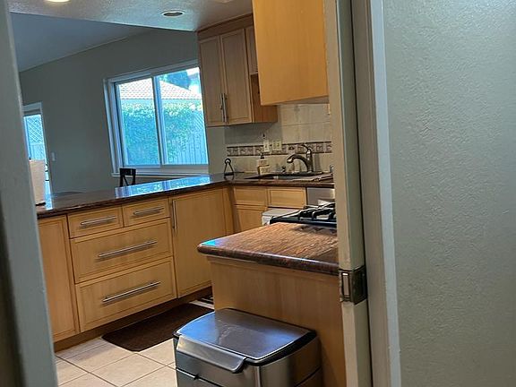 hallway entrance to kitchen with skylight
