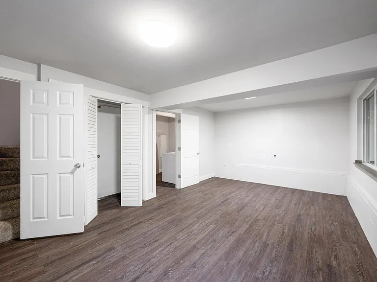Lower level with french doors to patio can also be a bedroom also with laundry room & closet