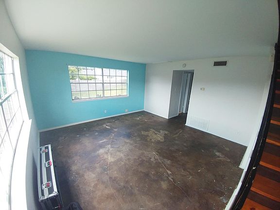 living room, entering through front door, windows facing back yard