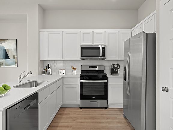 Kitchen in the Birch home plan by Trophy Signature Homes - REPRESENTATIVE PHOTO