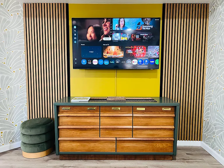 Stylish MCM TV wall opposite bed in master