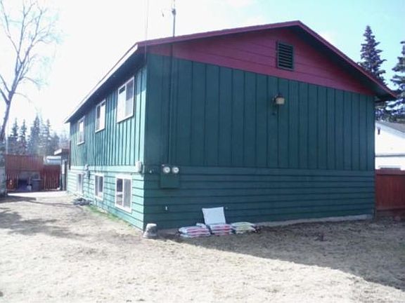 Rear of building with large fenced yard for pets and childre