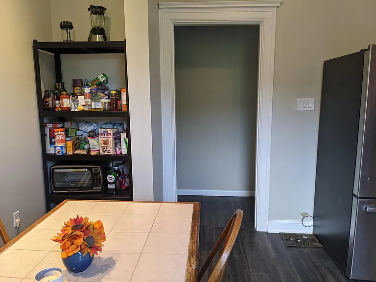 Kitchen seating and pantry area with door to hallway
