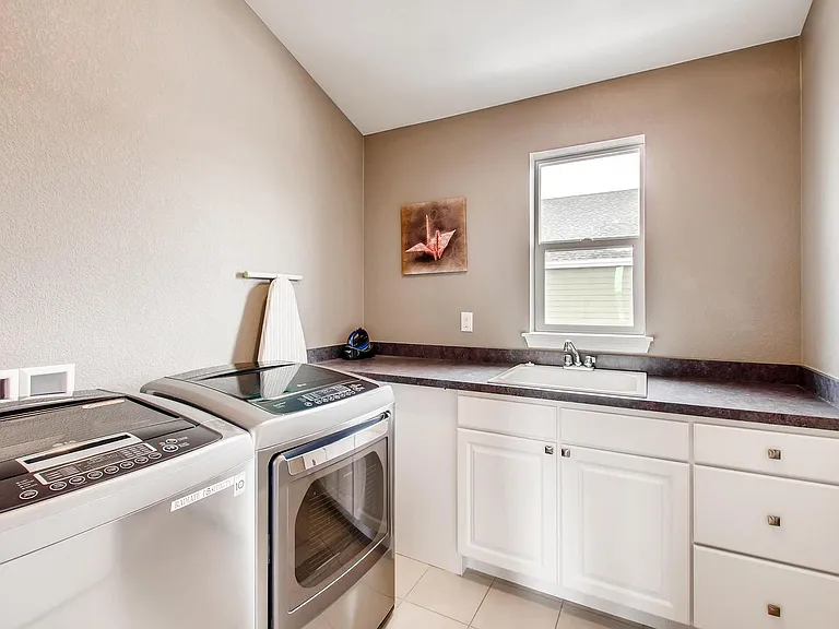 Upstairs laundry with sink and storage. New Washer/Dryer INCLUDED!