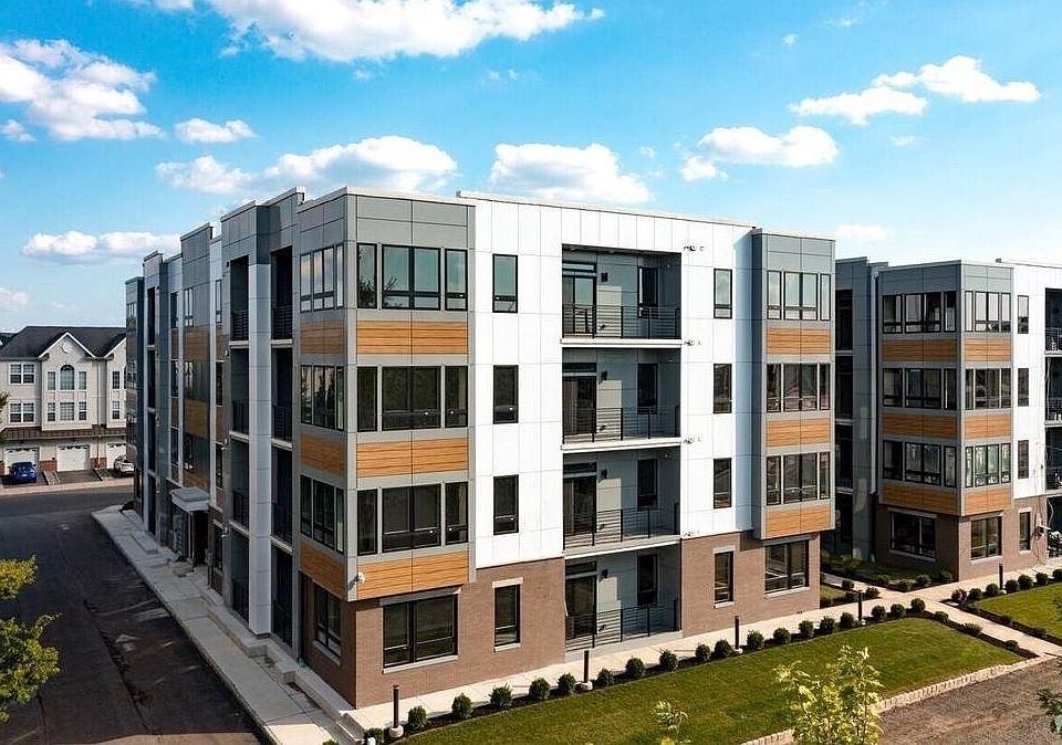 The modern neutral aesthetic extends from the interior to the exterior of the apartment complex.