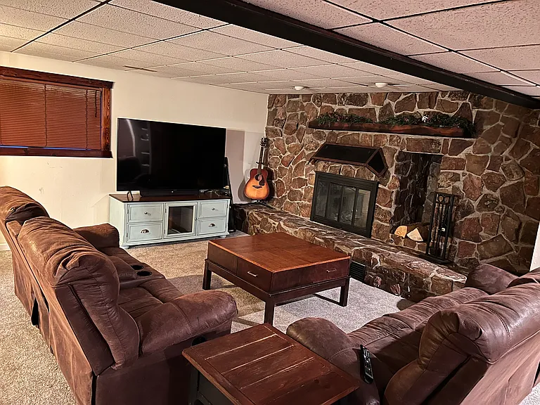 Family room with wood burning fireplace for those nostalgic winter days.