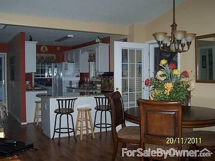 Great room : Open living/kitchen/dining with Alabama walnut flooring and granite countertops