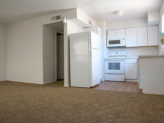 Open living , dining, kitchen area. Hallway leads to bedrooms and bathroom.