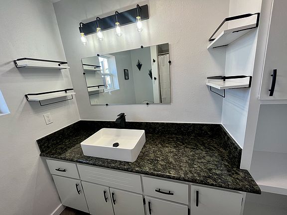 Updated upstairs bathroom with granite countertop and fountain sink.