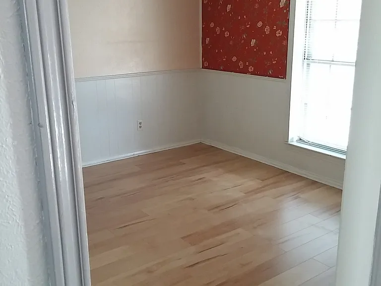 Dining room or office with built in bookshelf/ closet area.