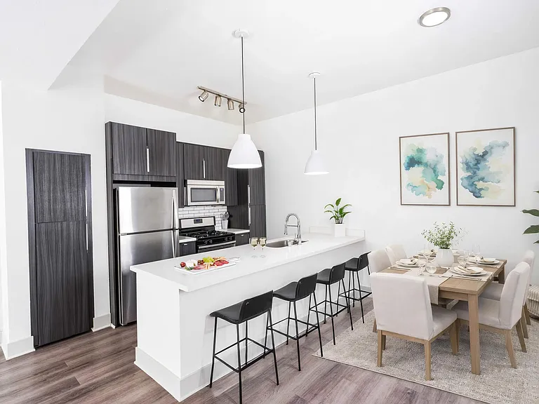 Spacious kitchen with extended island seating, clean finishes, and an open flow into the dining area.
