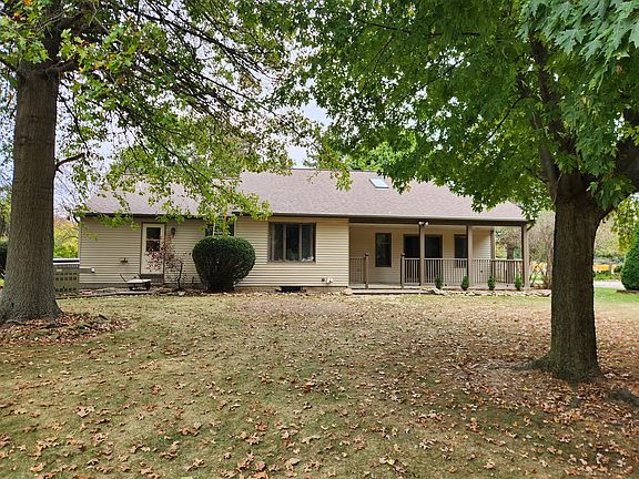 back of home with covered concrete patio