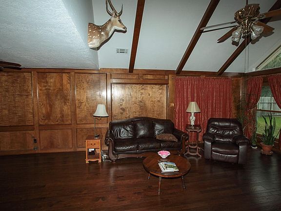 Rich hardwoods and vaulted ceilings with rustic beams