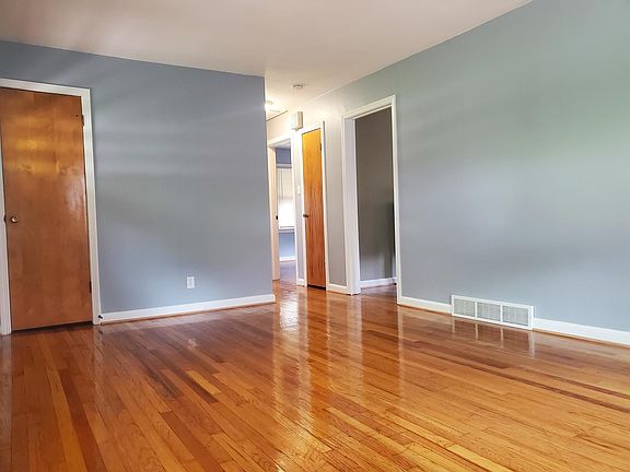 Enter into the living room that features refinished hard wood floors and a large closet for added storage.