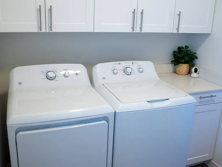 laundry area with tons of storage. This room has the garage access as well.