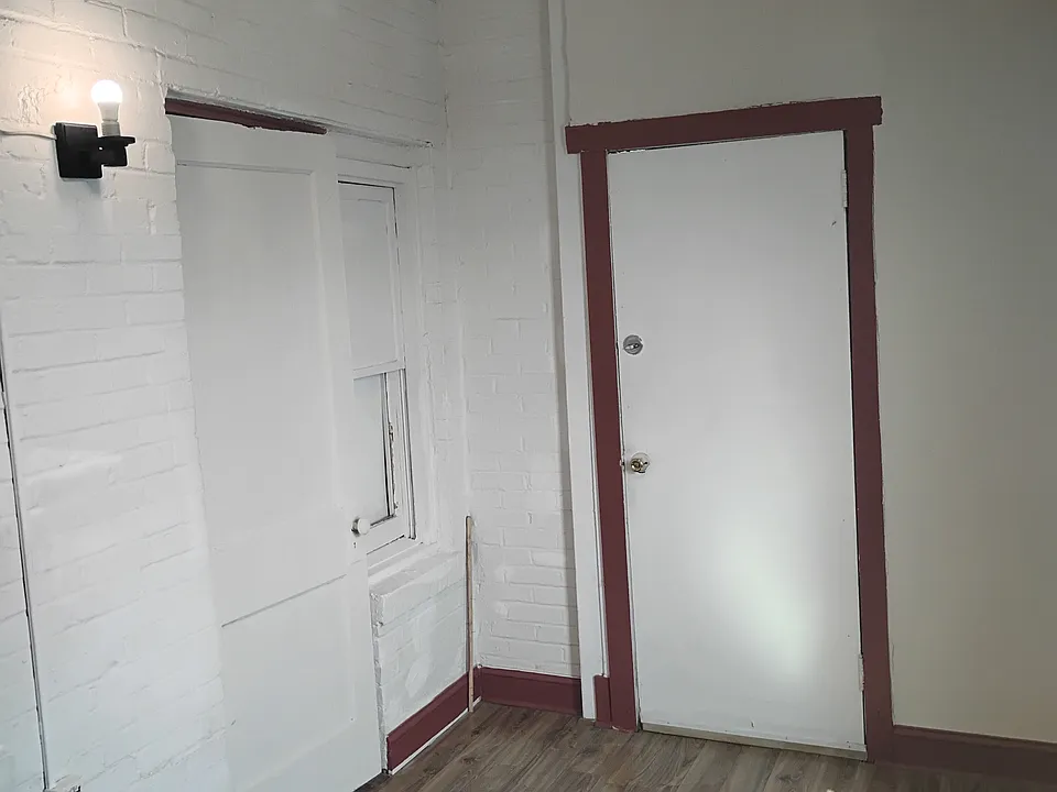 Enclosed porch with back door. Bedroom, office or living room