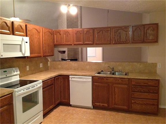 Spacious kitchen with new appliances and lots of cabinets.