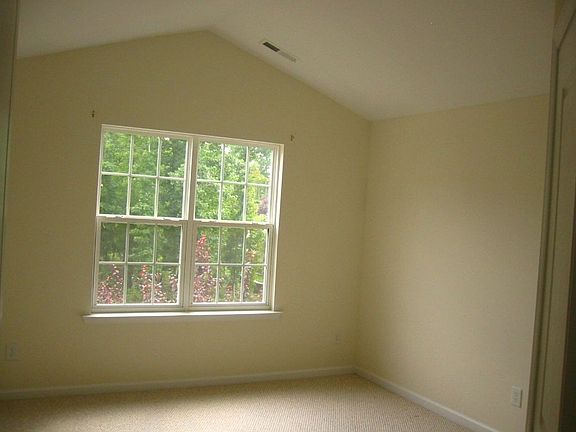 Master bedroom with vaulted ceiling and large walk in closet.