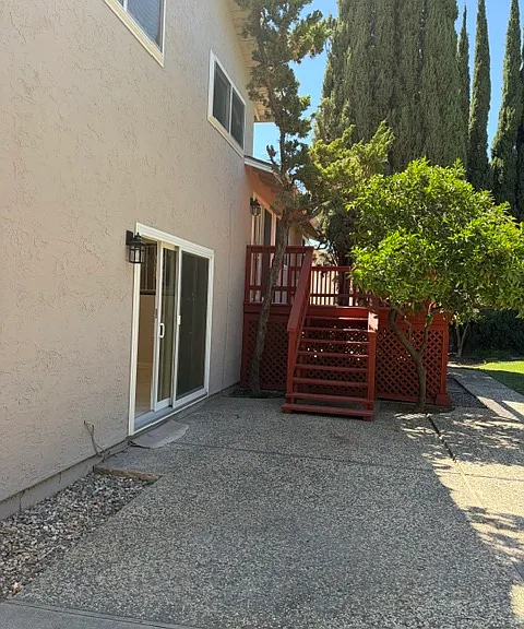 Patio to deck stairs and slider to family room