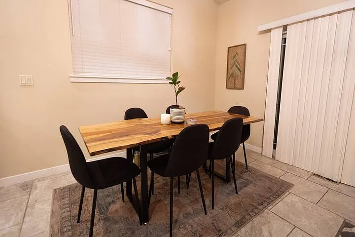 Dining region with sliding glass door leading to backyard