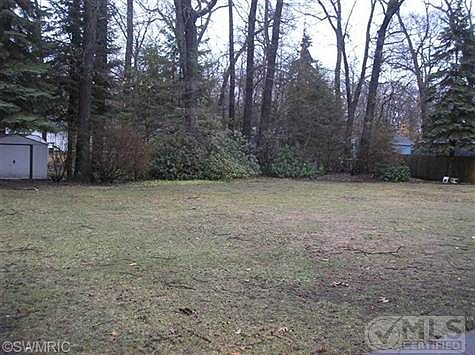 Large back yard with shed.