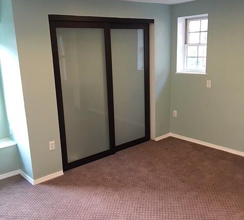 Large sunny bedroom with access to outdoor deck.