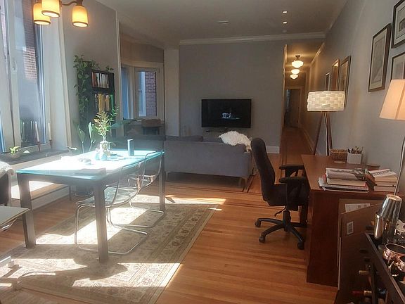 Living / Dining from Kitchen. Refinished original wood floors.